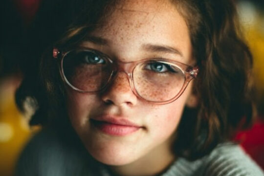 a school child wearing glasses