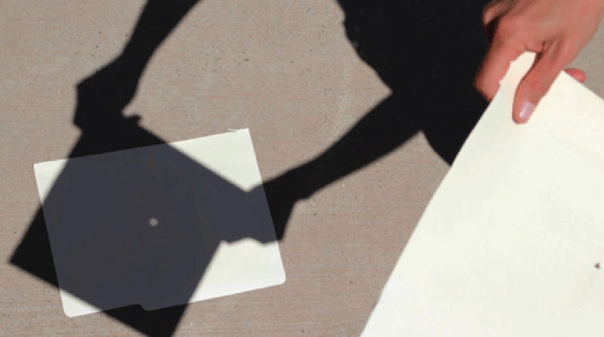 a pinhole projector using a piece of cardboard used to watch a solar eclipse safely